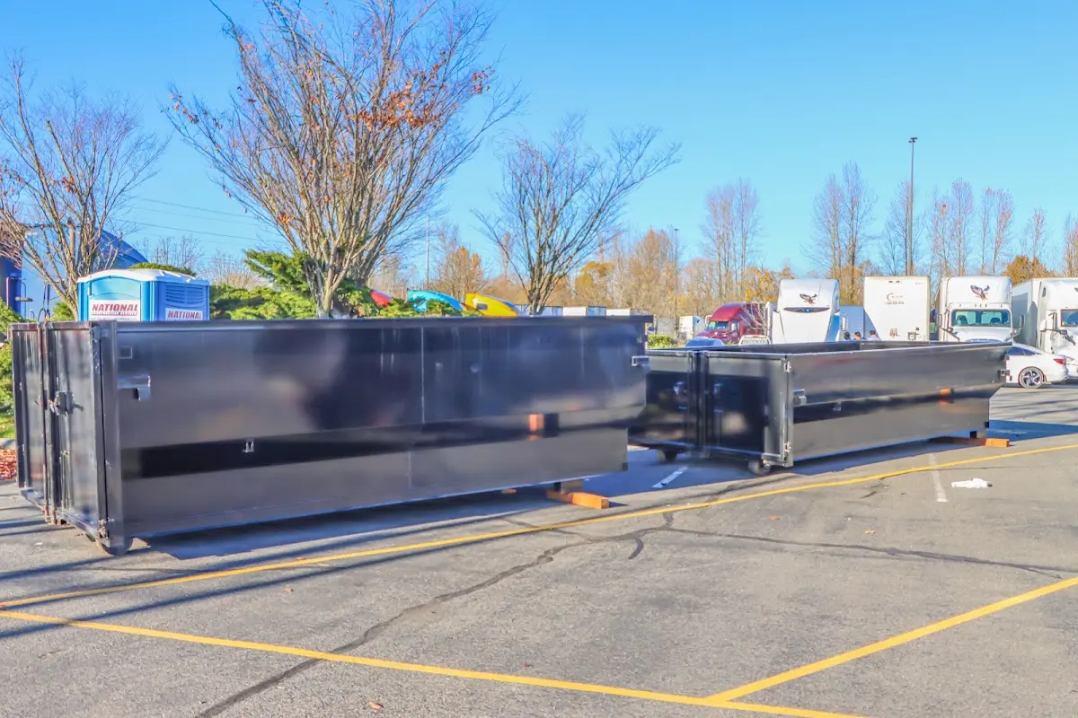 Professional dumpster rental service with roll-off container on residential driveway in Atoka